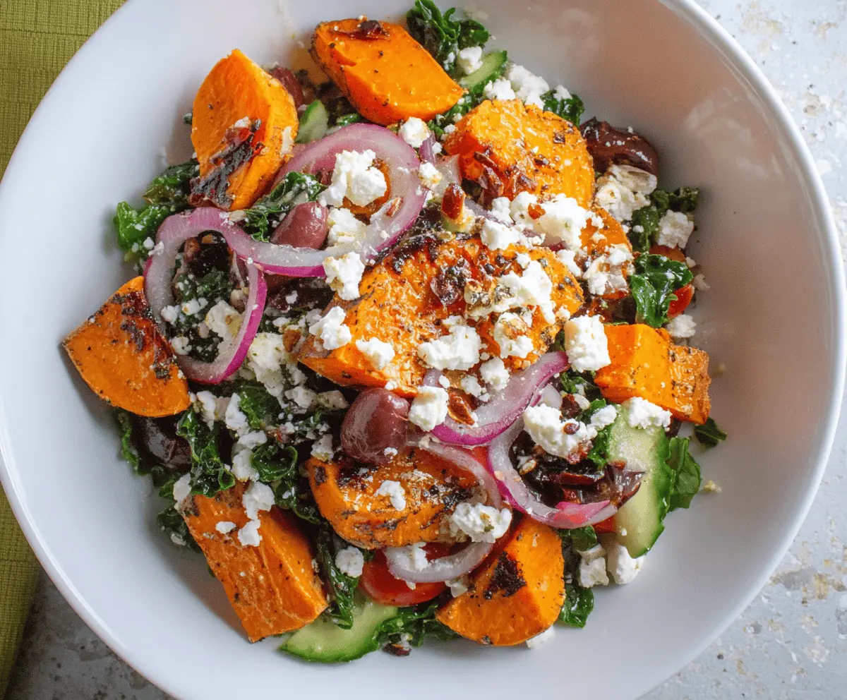 Colorful sweet potato Greek salad with fresh vegetables, feta cheese, and herbs in a bowl, perfect for a healthy meal.