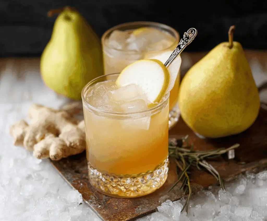 Refreshing Ginger Pear Bourbon Cocktail in a glass with ginger slices and pear for a festive drink