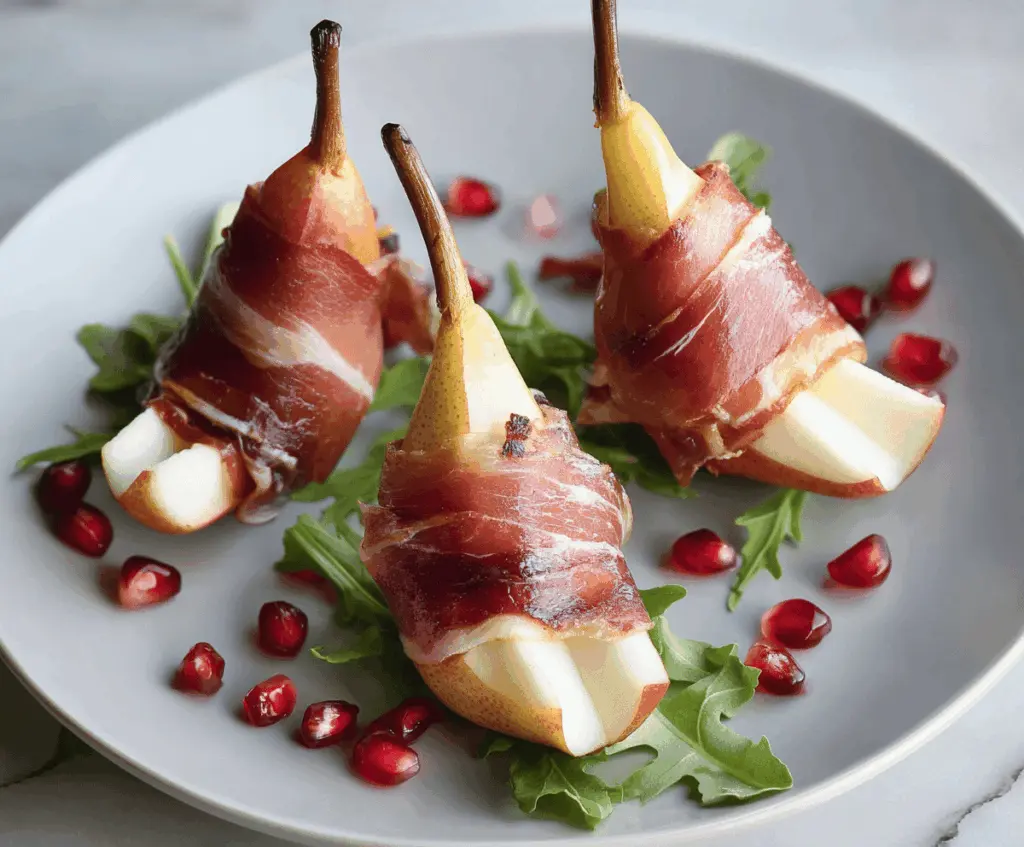 Prosciutto wrapped pears appetizer with fresh herbs and honey drizzle.