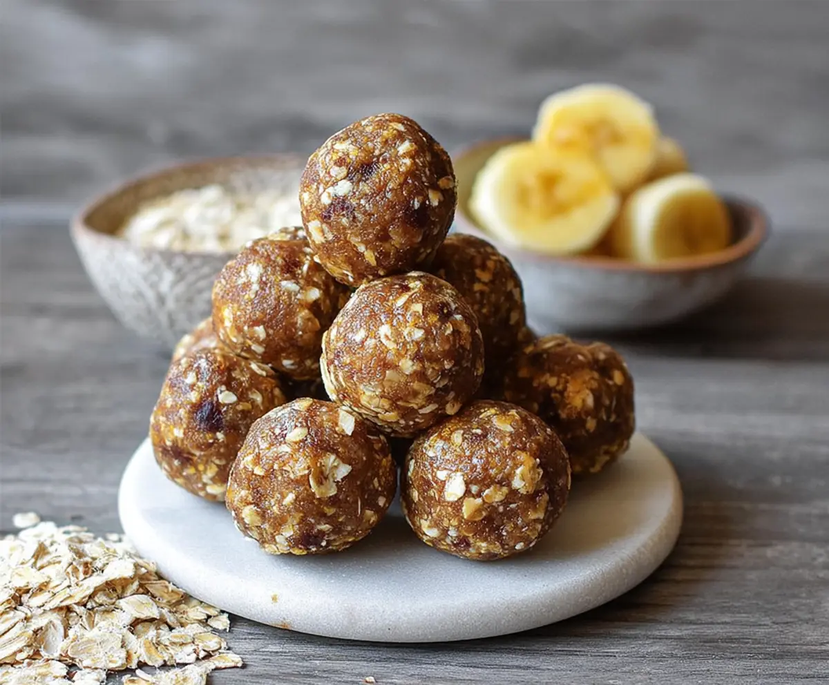 Healthy Banana Energy Balls with nuts and oats on a wooden table - delicious snack recipe