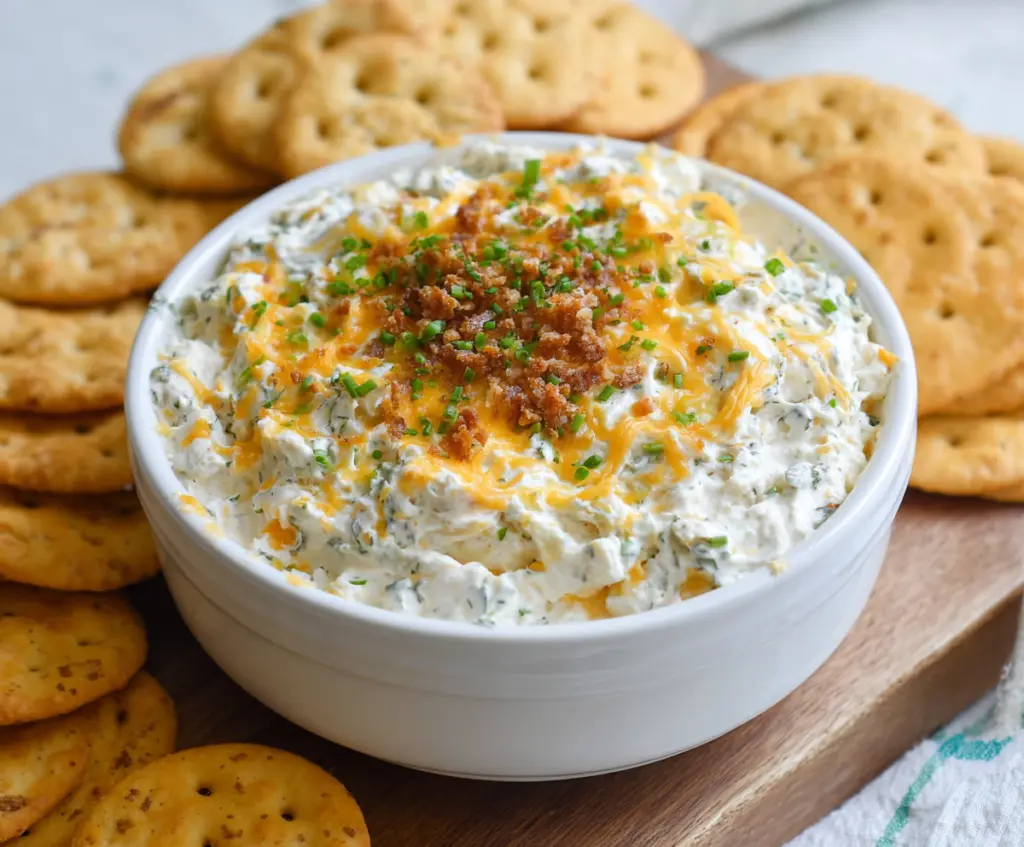 Creamy Cheddar Ranch Crack Dip served with crunchy vegetables and chips.