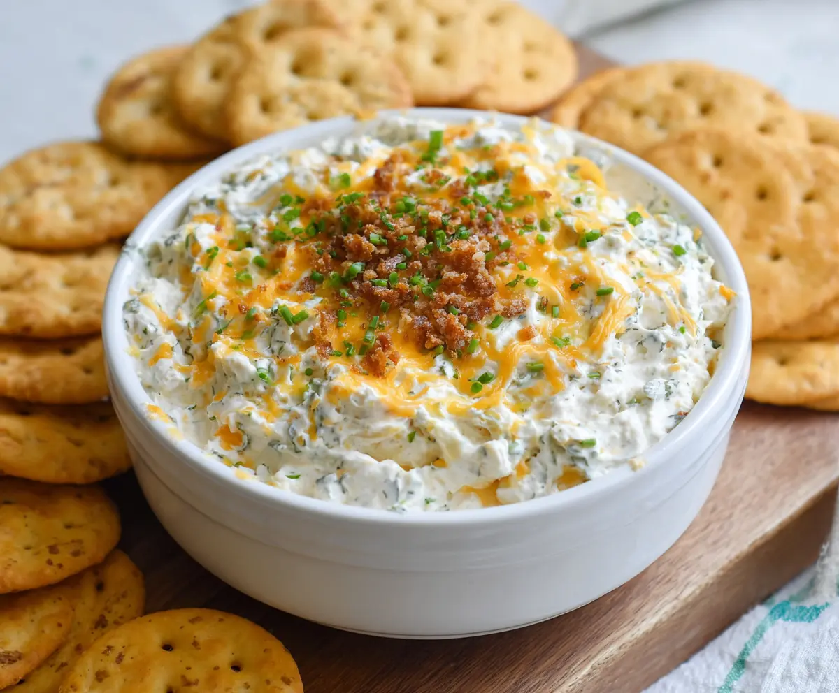 Creamy Cheddar Ranch Crack Dip served with crunchy vegetables and chips.