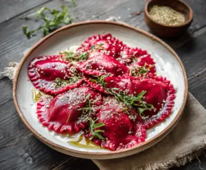 Delicious beet ravioli with vibrant red filling and fresh herbs on a rustic plate