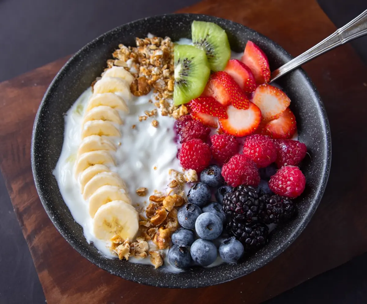 Colorful fruits and creamy yogurt in a breakfast bowl, perfect for a healthy start to your day.
