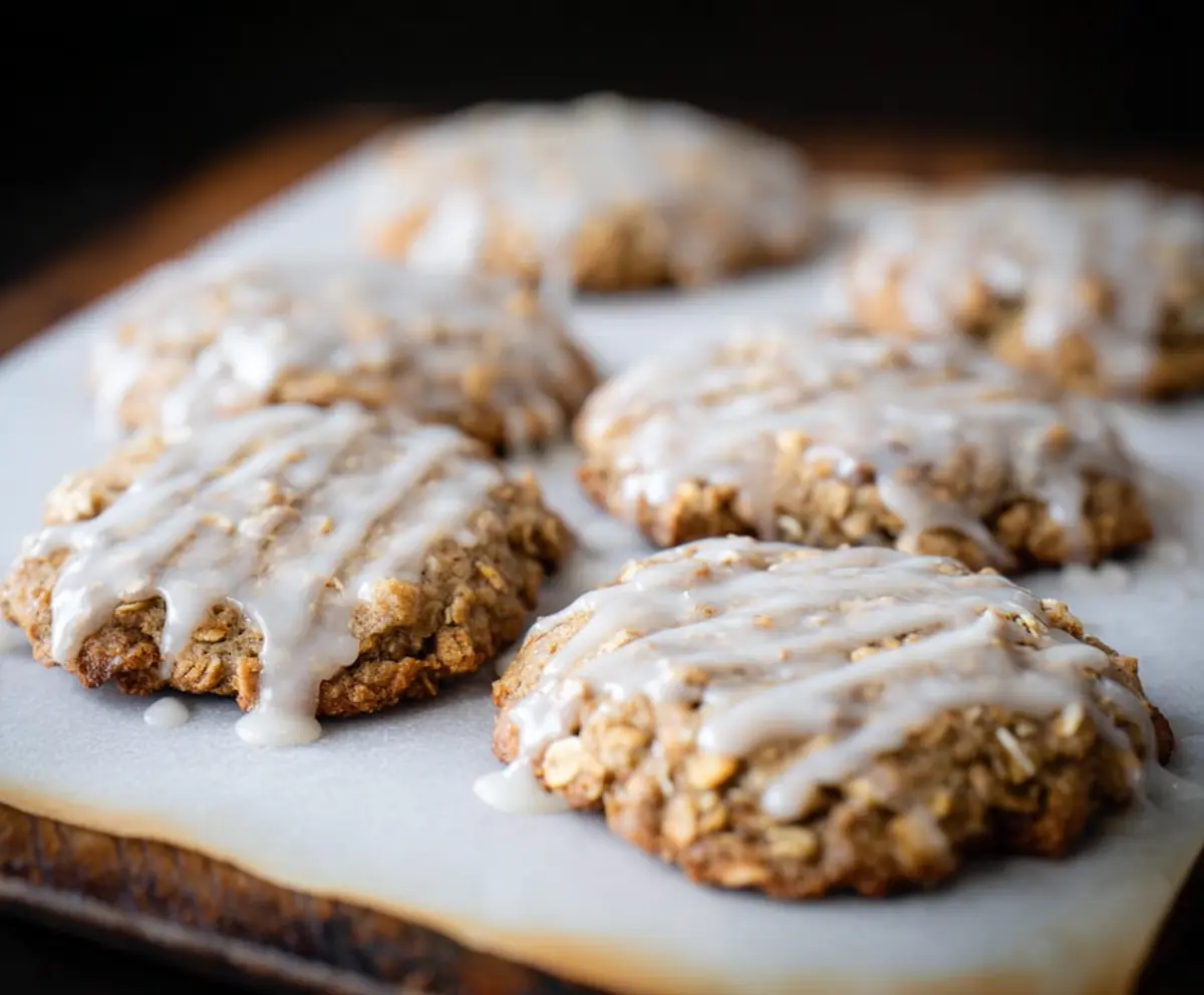 Delicious sourdough discard glazed oatmeal cookies on a rustic plate.
