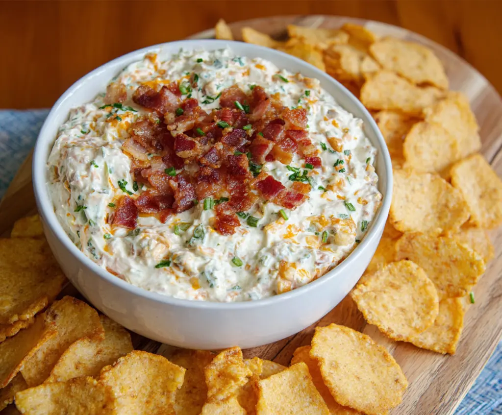 Creamy Bacon Cheddar Ranch Dip served with fresh vegetables and chips.