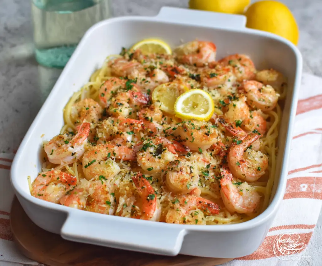 Delicious Shrimp Scampi Bake with golden crust and fresh herbs, served on a white plate.