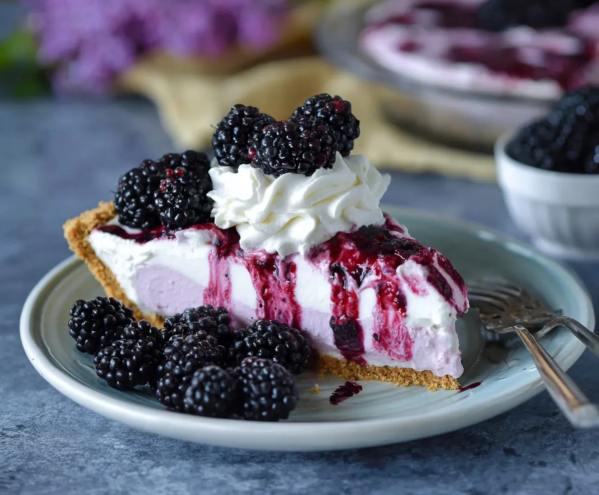 Delicious Blackberry Ice Cream Pie topped with fresh blackberries and mint leaves.