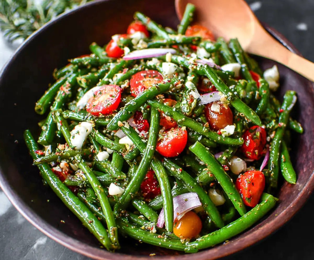 Fresh green bean salad with cherry tomatoes and herbs, perfect for summer meals.