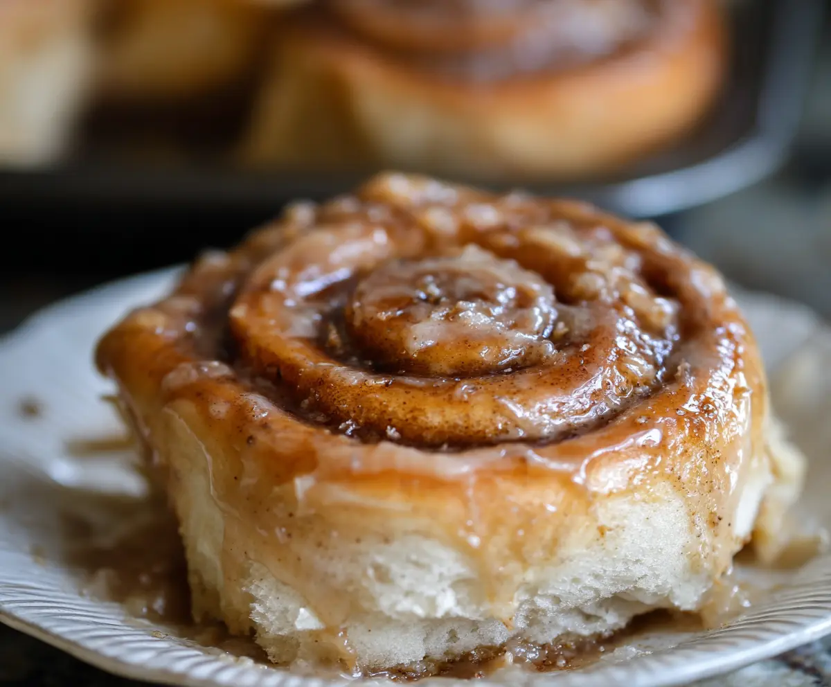 Delicious sourdough apple cider cinnamon rolls fresh out of the oven with a golden brown crust.